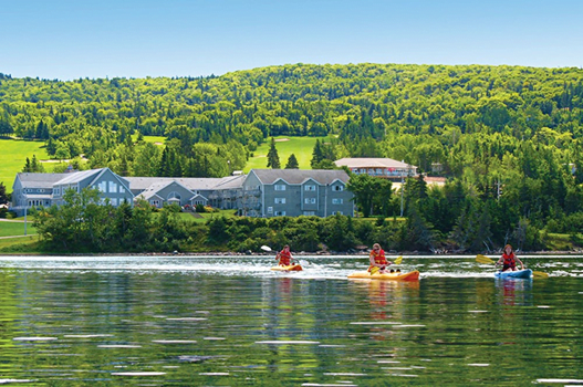Kayakers on our lakeside beach at the Dundee Recreation Club. PHOTO CREDIT: Dundee Resort and Golf Club.